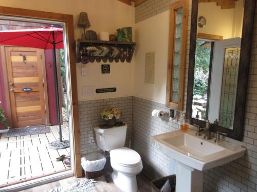 a bathroom with a toilet and a sink at Magnolia Petal in Ganges