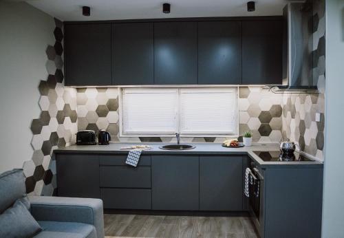 a kitchen with black cabinets and a counter top at N95 in Bitola