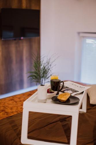 a white coffee table with a plate of food on it at N95 in Bitola