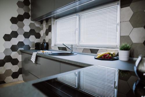 a kitchen with a sink and a plate of fruit on the counter at N95 in Bitola