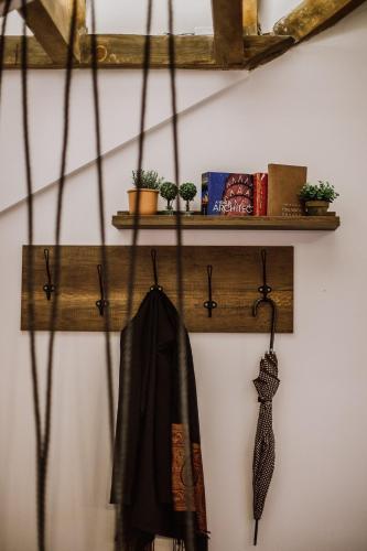 a coat hanging on a wall with a shelf at N95 in Bitola