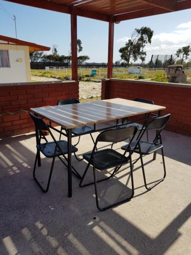 a table and chairs sitting under a pavilion at APARTHOTEL Santa Maria in Punta de Choros
