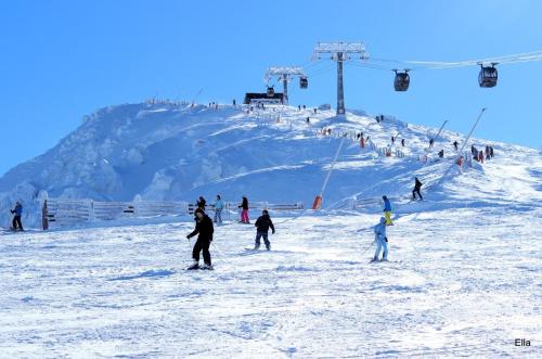 a group of people skiing on a ski slope at Chalupa Liptovský Mikuláš in Liptovský Mikuláš