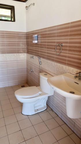 a bathroom with a toilet and a sink at Fisherman's Cottage El Nido in El Nido