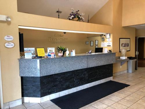 a lobby with a counter in a restaurant at Baymont by Wyndham Fort Wayne in Fort Wayne