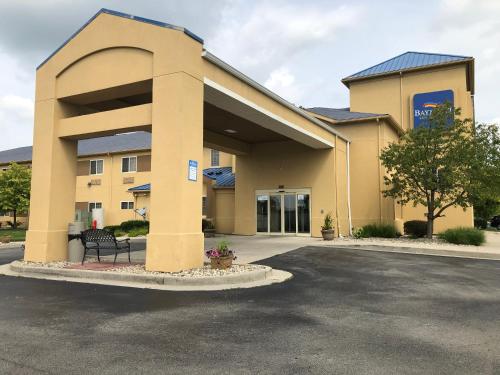 a parking lot in front of a building at Baymont by Wyndham Fort Wayne in Fort Wayne