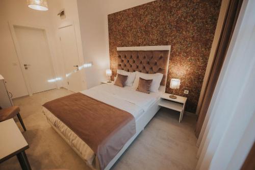 a bedroom with a large bed in a room at Hotel Marabella in Sibiu