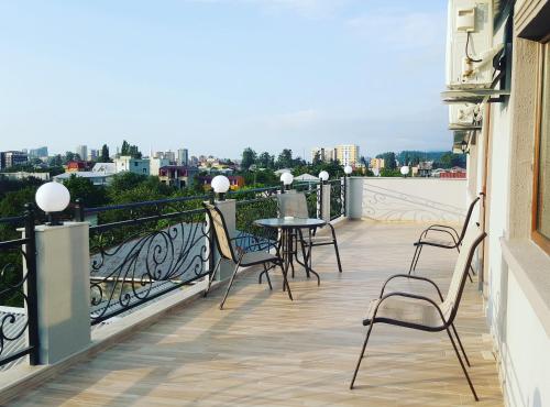 a balcony with chairs and a table on a balcony at MY HOUSE in Batumi