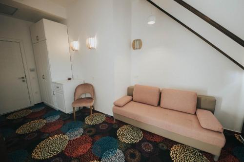 a living room with a couch and a chair at Hotel Marabella in Sibiu