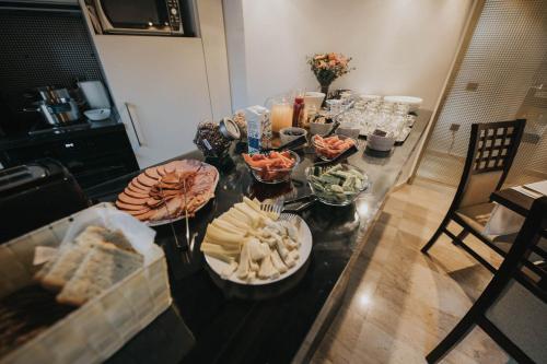 a table with several bowls of food on it at Hotel Marabella in Sibiu