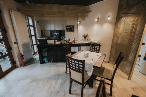 a kitchen with a table and chairs in a room at Hotel Marabella in Sibiu