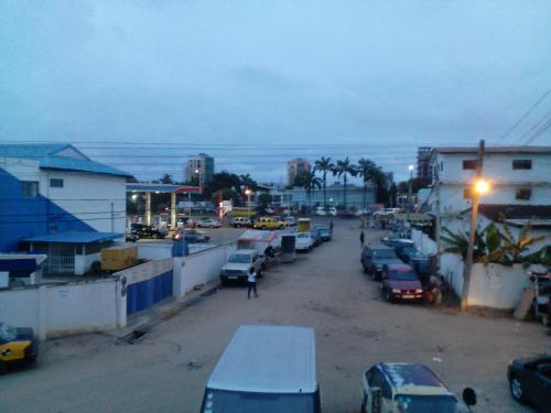 a street with cars parked in a parking lot at Feehi's Place in Accra