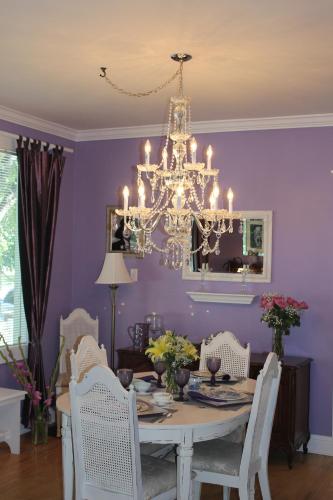 a dining room with a table and a chandelier at Charles Street Vacation Home in Lethbridge