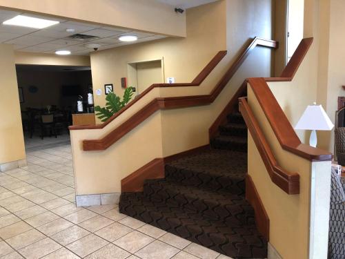 a stairway in a hospital lobby with a staircase at Baymont by Wyndham Fort Wayne in Fort Wayne