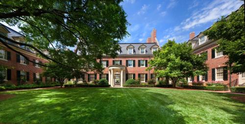 a large brick building with a large grass yard at The Carolina Inn, a Destination by Hyatt Hotel in Chapel Hill