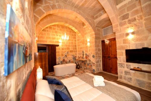 a living room with a couch and a tv in a building at The Lodge in Cospicua