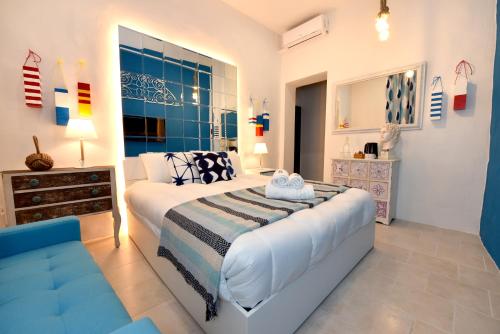 a bedroom with a bed and a couch in it at The Lodge in Cospicua