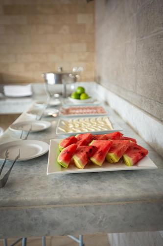 a table with a plate of watermelons on it at Villa Royale Panama in Panama City