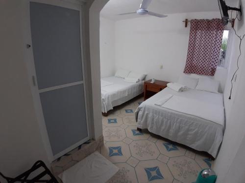 Ένα ή περισσότερα κρεβάτια σε δωμάτιο στο Habitaciones Chiquil Ha