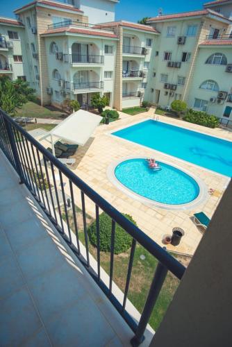 a swimming pool in front of a large building at Sunrise Beach Club (Hera B6@) in Kalecik