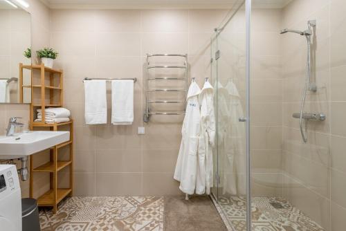 a bathroom with a shower and a sink at Modern holiday apartment Vilnius in Vilnius