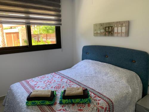 a bedroom with a bed with two towels on it at Arenal Dream The Beachfront Paradise in Jávea