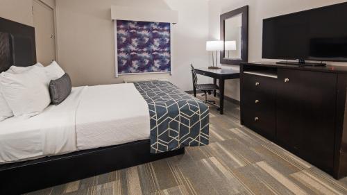 a hotel room with a bed and a flat screen tv at Best Western Plus Wilkes Barre-Scranton Airport Hotel in Pittston