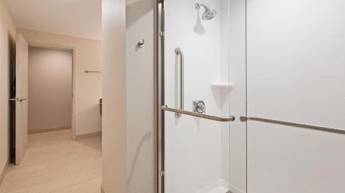 a bathroom with a shower with a glass door at Best Western Plus Wilkes Barre-Scranton Airport Hotel in Pittston