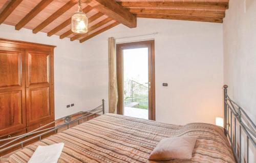 een slaapkamer met een bed en een raam bij Il Giardino degli Olivi in Castiglion Fiorentino