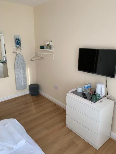a bedroom with a flat screen tv on a wall at Smeaton serviced Accommodation in Liverpool