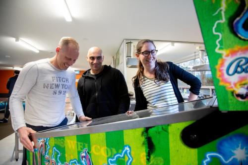 a group of three people standing next to a counter at City Lodge Accommodation in Auckland