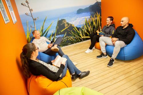 a group of people sitting in chairs in a room at City Lodge Accommodation in Auckland