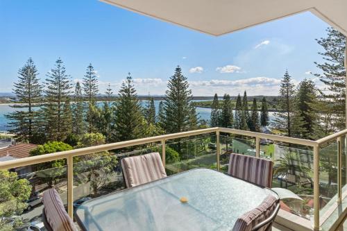 a view from the balcony of a house with a table and chairs at Northpoint Apartments in Port Macquarie