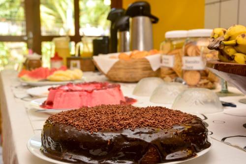 a table with a chocolate cake on a table at Pousada Enseada Dos Golfinhos in Pipa