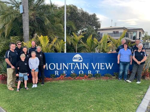 people standing next to a sign at Mountain View Resort in Shoalhaven Heads