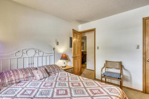 a bedroom with a large bed and a chair at Snowfire 209B in Angel Fire