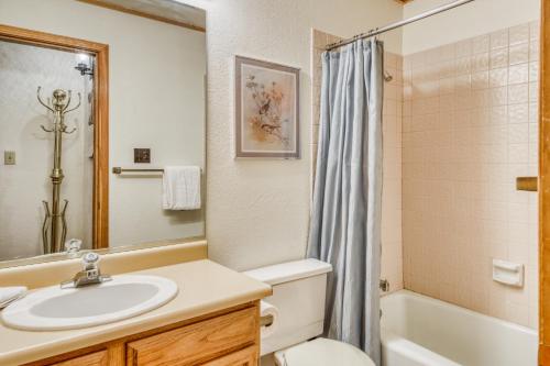 a bathroom with a sink and a toilet and a tub at Snowfire 209B in Angel Fire