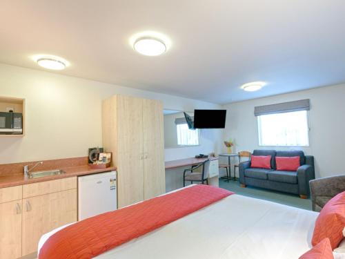 ein Schlafzimmer mit einem Bett, eine Küche und ein Wohnzimmer in der Unterkunft Bella Vista Motel Westport in Westport