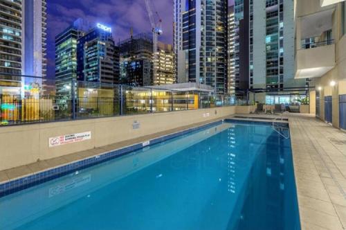 a large swimming pool in a city at night at S&P Apartments - Albert St in Brisbane