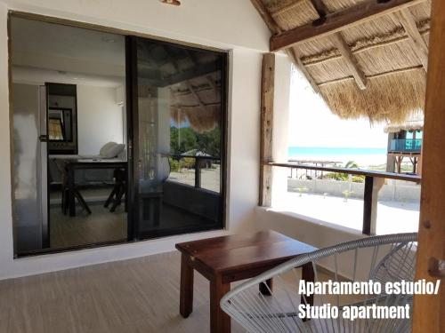 a room with a table and a view of the ocean at Casa Kay in Playa del Carmen