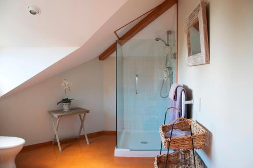 a bathroom with a glass shower in a attic at Waiwurrie Coastal Farm Lodge in Mahinepua