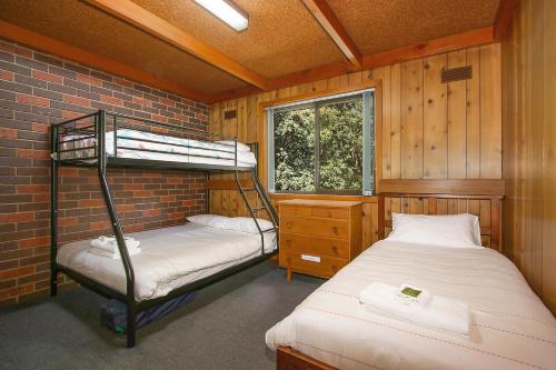 a bedroom with two bunk beds and a window at Kalamunda 6 - On the Rail Trail in Bright