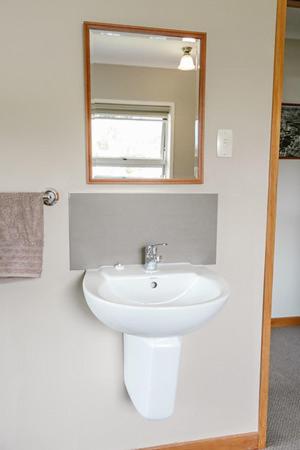 a bathroom with a sink and a mirror at The Nunnery in Te Aroha