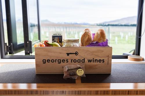 a box filled with fruit and vegetables on a table at Romantic Vineyard getaway in Waipara
