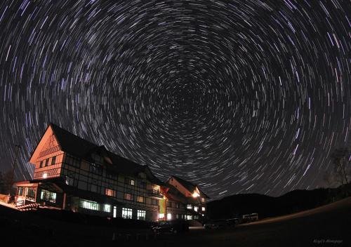 a building with a star trails in the sky at Shirabiso Kogen Amanogawa in Iida