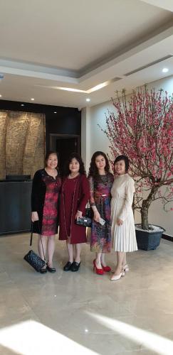 a group of women posing for a picture in a lobby at Max Boutique Hotel in Cao Bằng