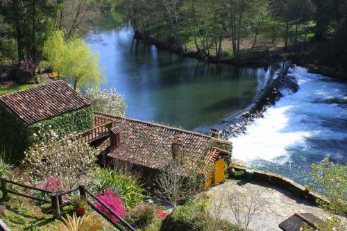 a view of a river with a waterfall at Casas Da Azenha in Vila Nova de Cerveira