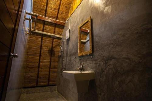 a bathroom with a sink and a mirror at Cicada Lanta in Ko Lanta
