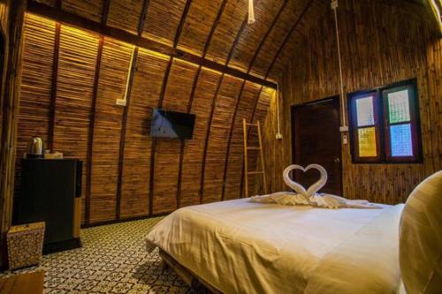 a bedroom with a bed with a heart on it at Cicada Lanta in Ko Lanta
