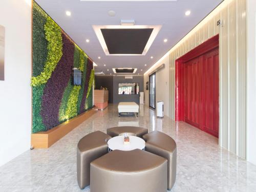 a lobby with a green wall in a building at TT Dorf Hotel Matang in Taiping